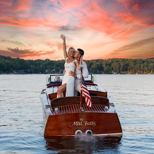 A couple dressed in formal attire stands on a boat named 