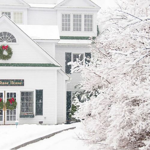 A snow-covered house adorned with Christmas wreaths, labeled 