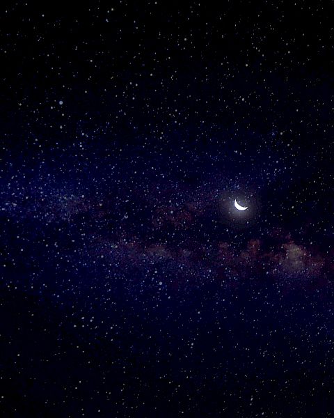 A starry night sky with a crescent moon and a hint of the Milky Way galaxy.